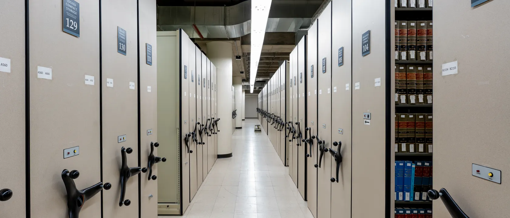 Rows of compact archive shelving in a records storage room